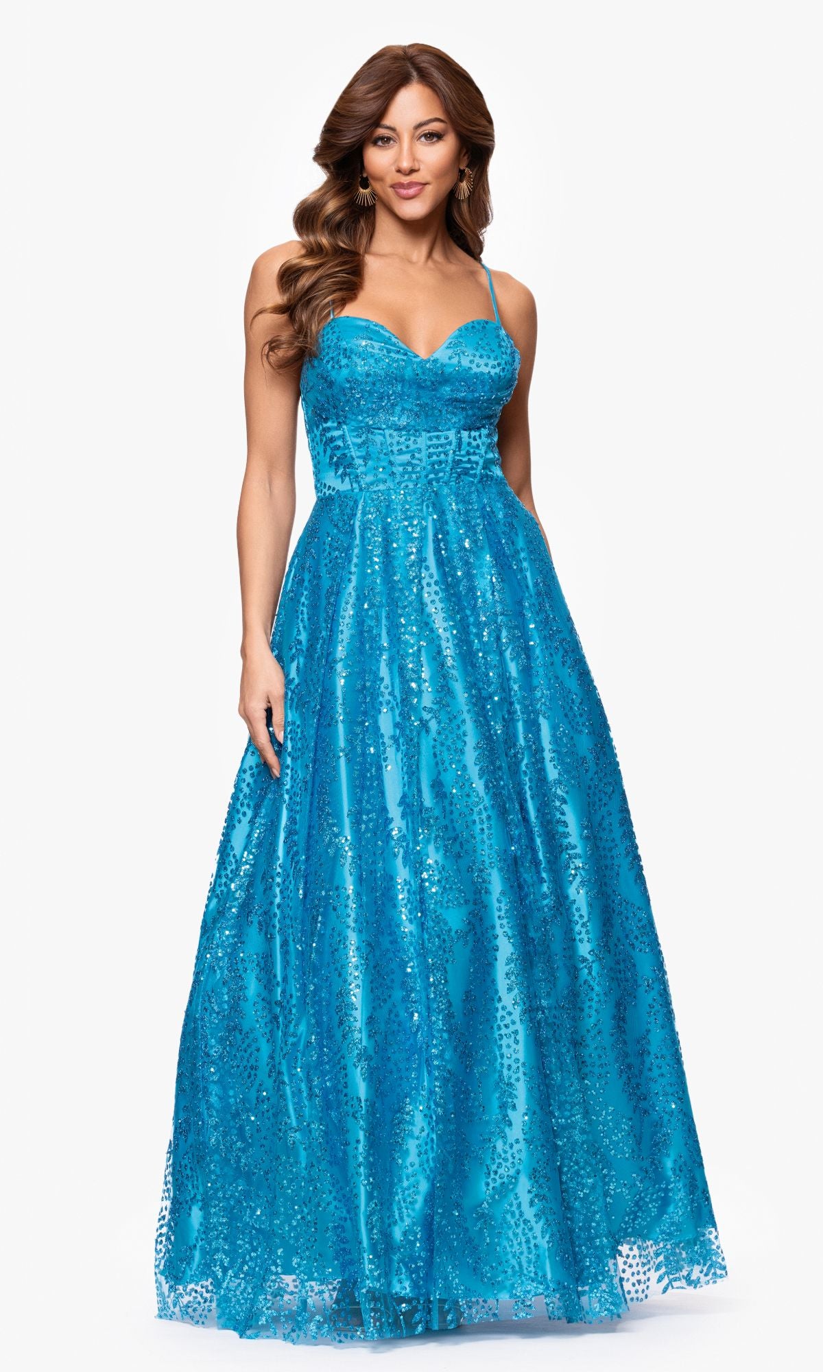 A woman models the Blondie Nites 4617BN Long Glitter Prom Dress—a sleeveless, blue sequin A-line gown with spaghetti straps and a corset-style bodice—standing against a plain white background.
